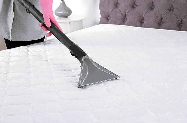 woman cleaning memory foam mattress